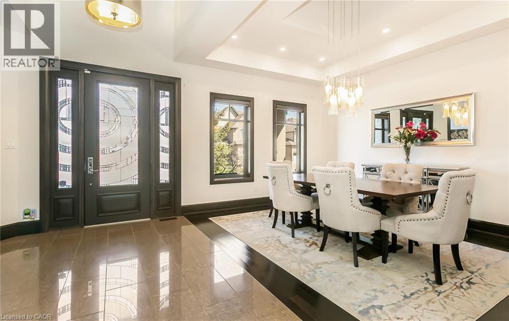 Dining room with a raised ceiling, hanging lights, and wood finished floors - 24 Jacob Gingrich Drive, Kitchener, ON - Indoor Photo Showing Dining Room