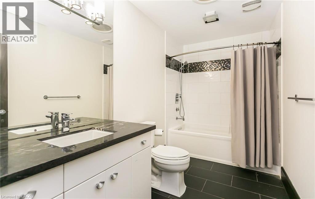 Bathroom with vanity, shower / tub combo, and dark tile patterned flooring - 24 Jacob Gingrich Drive, Kitchener, ON - Indoor Photo Showing Bathroom