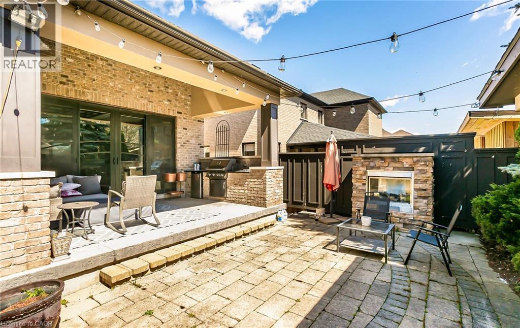 View of patio with an outdoor kitchen, an outdoor stone fireplace, and french doors - 24 Jacob Gingrich Drive, Kitchener, ON - Outdoor With Deck Patio Veranda With Exterior