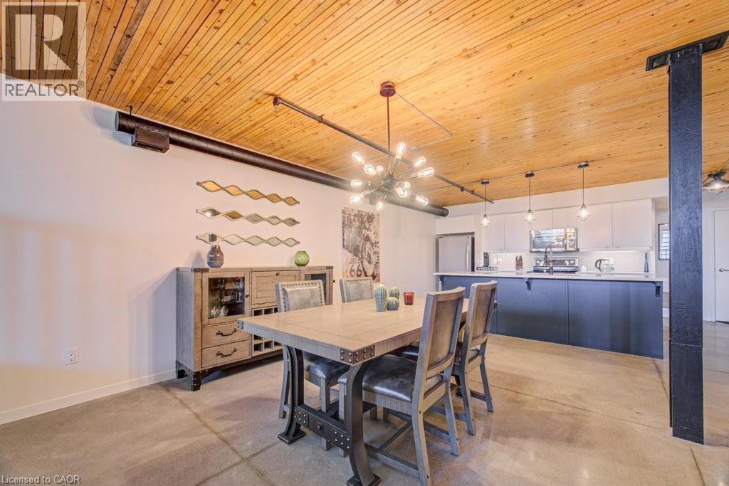Dining area featuring wooden ceiling and concrete flooring - 85 Spruce Street Unit# 103, Cambridge, ON - Indoor Photo Showing Dining Room