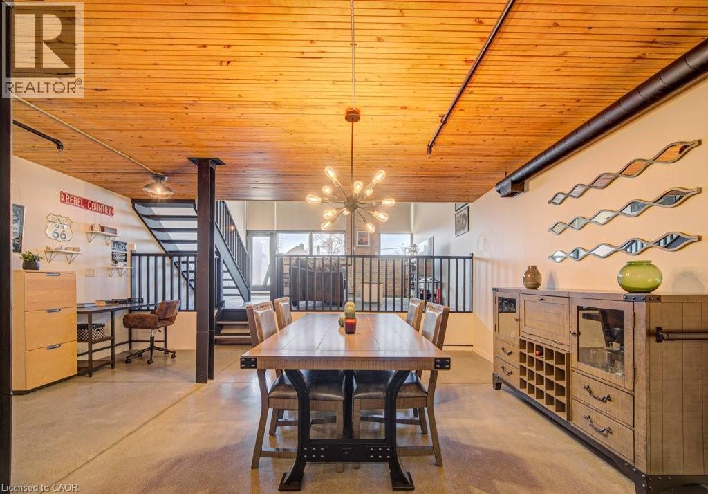 Dining space with concrete floors, a chandelier, and wooden ceiling - 85 Spruce Street Unit# 103, Cambridge, ON - Indoor Photo Showing Dining Room