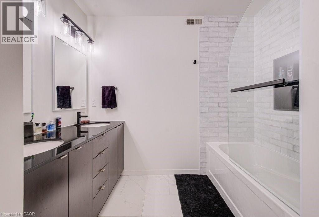 Bathroom with double vanity and light marble finish flooring - 85 Spruce Street Unit# 103, Cambridge, ON - Indoor Photo Showing Bathroom
