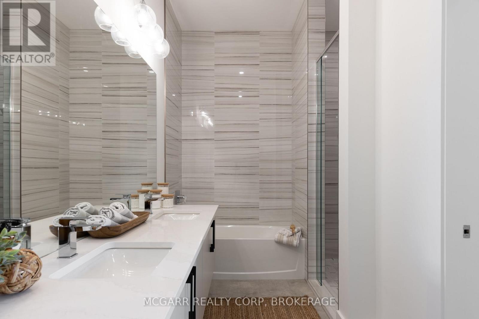 Long vanity with 2 sinks - 403 - 77 Yates Street, St. Catharines (Downtown), ON - Indoor Photo Showing Bathroom