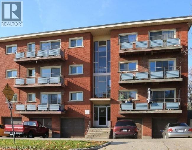 View of apartment building / complex featuring a garage - 151 Siebert Avenue, Kitchener, ON - Outdoor With Balcony With Facade