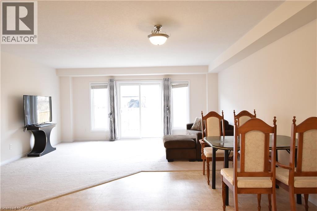 Living area with light carpet and baseboards - 52 Meadowridge Street, Kitchener, ON - Indoor