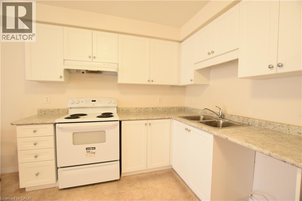 Kitchen featuring electric range and white cabinets - 52 Meadowridge Street, Kitchener, ON - Indoor Photo Showing Kitchen With Double Sink