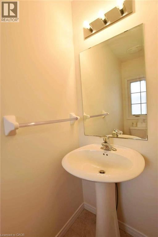 Bathroom with light tile patterned floors and baseboards - 52 Meadowridge Street, Kitchener, ON - Indoor Photo Showing Bathroom