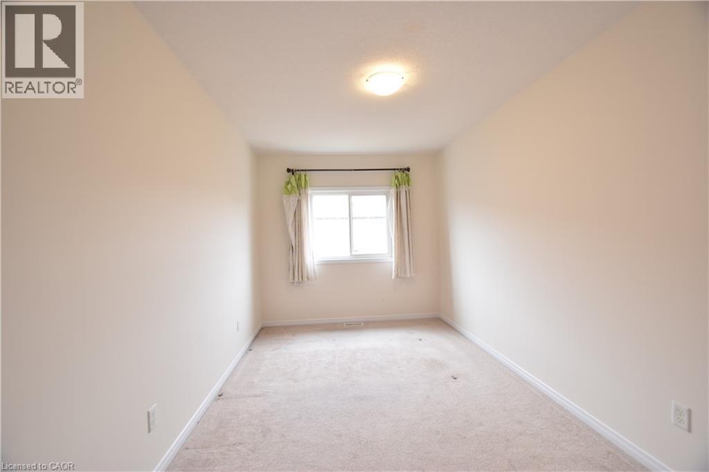 Unfurnished room featuring carpet and baseboards - 52 Meadowridge Street, Kitchener, ON - Indoor Photo Showing Other Room