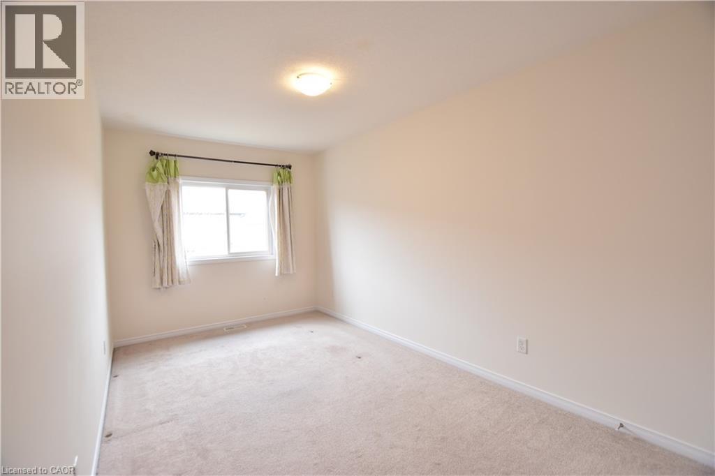 Carpeted spare room featuring baseboards - 52 Meadowridge Street, Kitchener, ON - Indoor Photo Showing Other Room