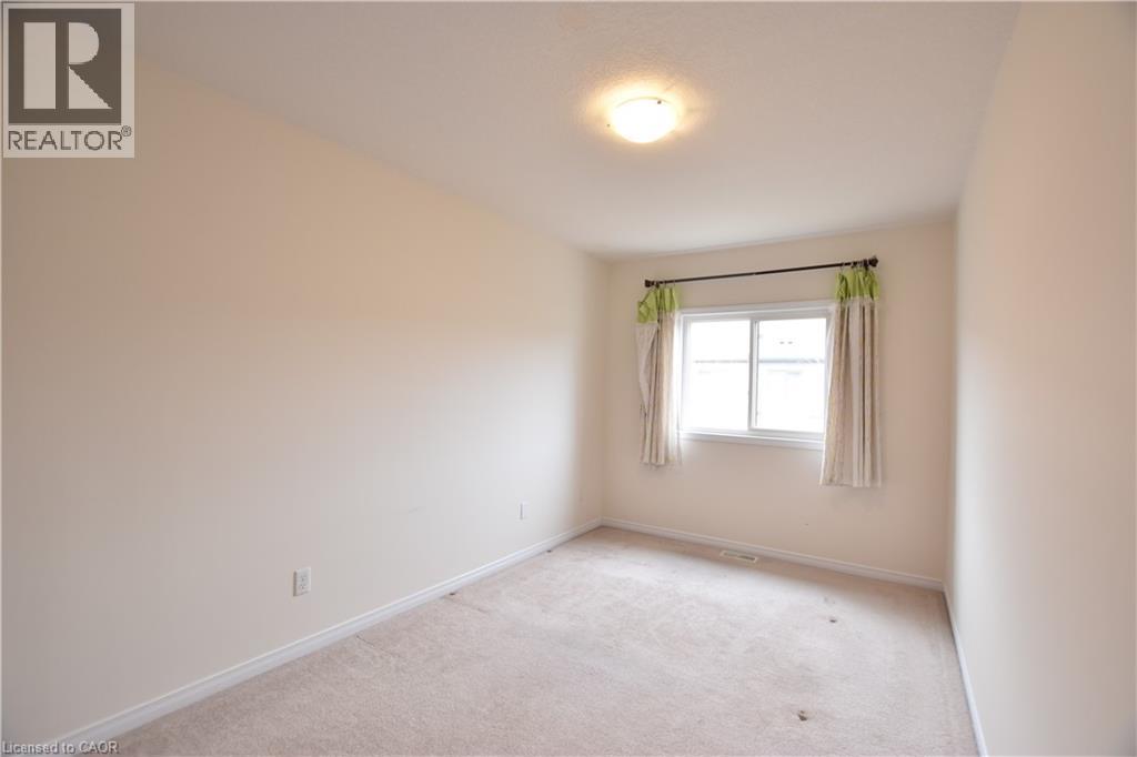 Carpeted empty room featuring baseboards - 52 Meadowridge Street, Kitchener, ON - Indoor Photo Showing Other Room