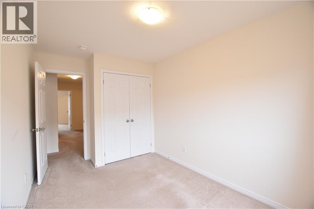 Unfurnished bedroom with light colored carpet and a closet - 52 Meadowridge Street, Kitchener, ON - Indoor Photo Showing Other Room