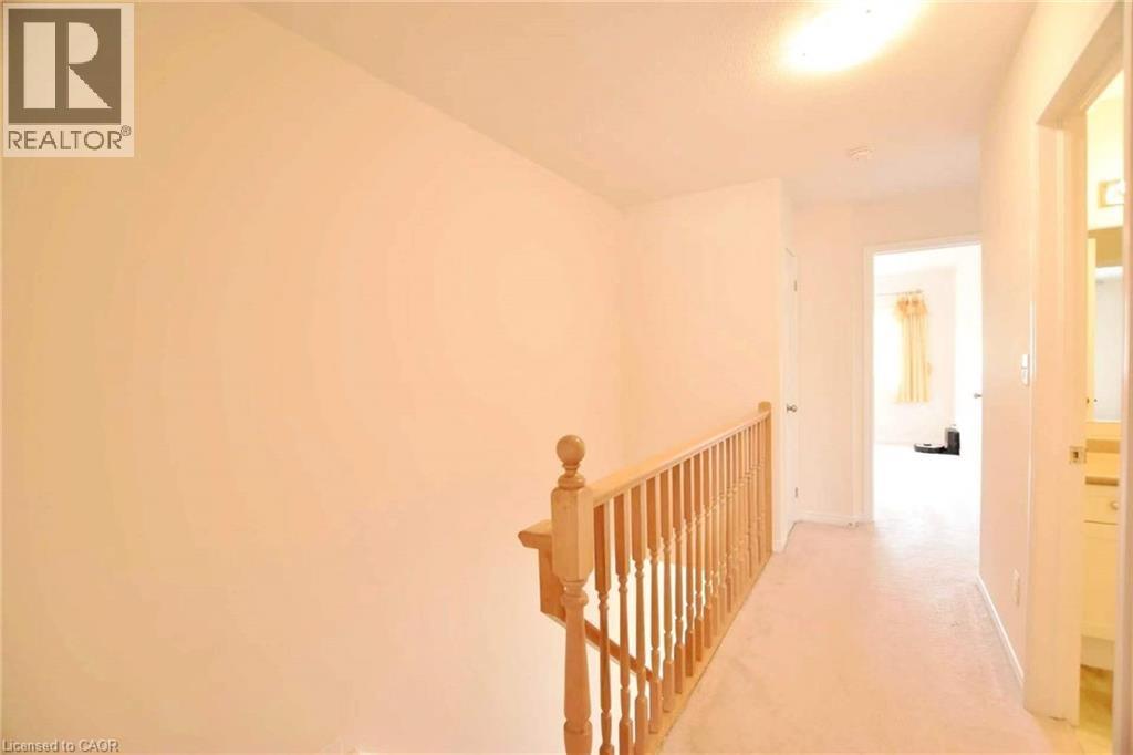 Hallway with an upstairs landing and light carpet - 52 Meadowridge Street, Kitchener, ON - Indoor Photo Showing Other Room