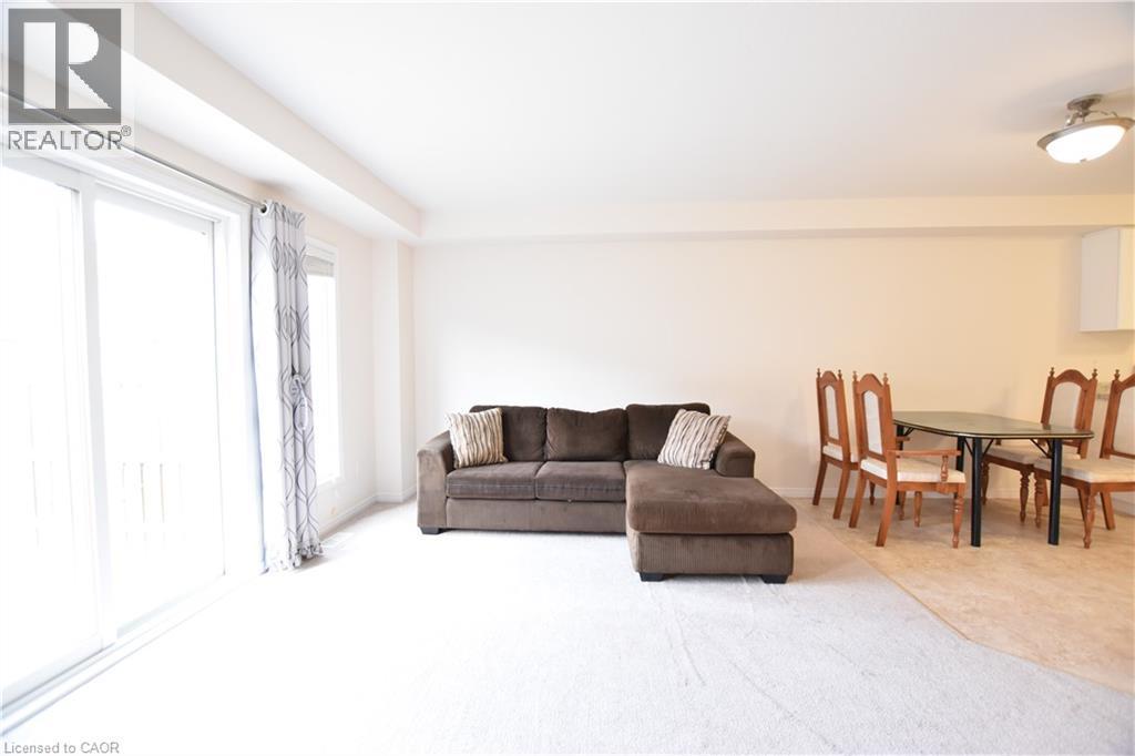 Living room featuring light carpet - 52 Meadowridge Street, Kitchener, ON - Indoor