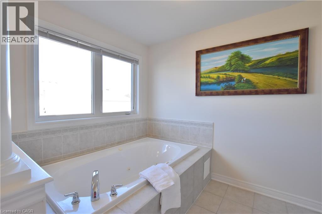 Bathroom featuring a jetted tub and light tile patterned floors - 512 Terrington Crescent, Kitchener, ON - Indoor Photo Showing Bathroom