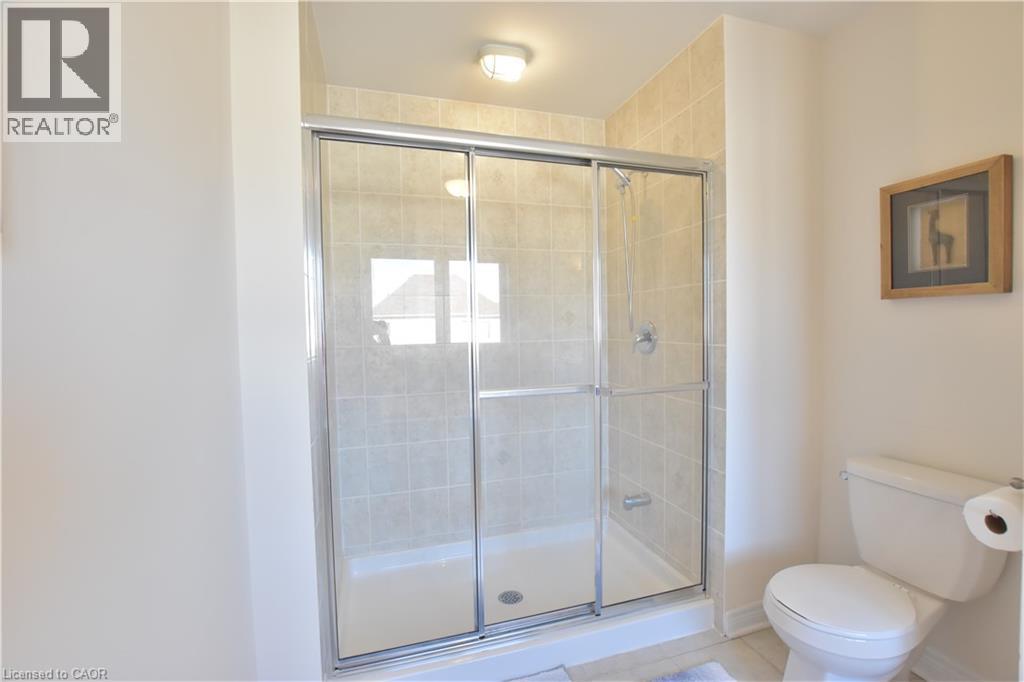 Bathroom featuring a shower stall and light tile patterned flooring - 512 Terrington Crescent, Kitchener, ON - Indoor Photo Showing Bathroom