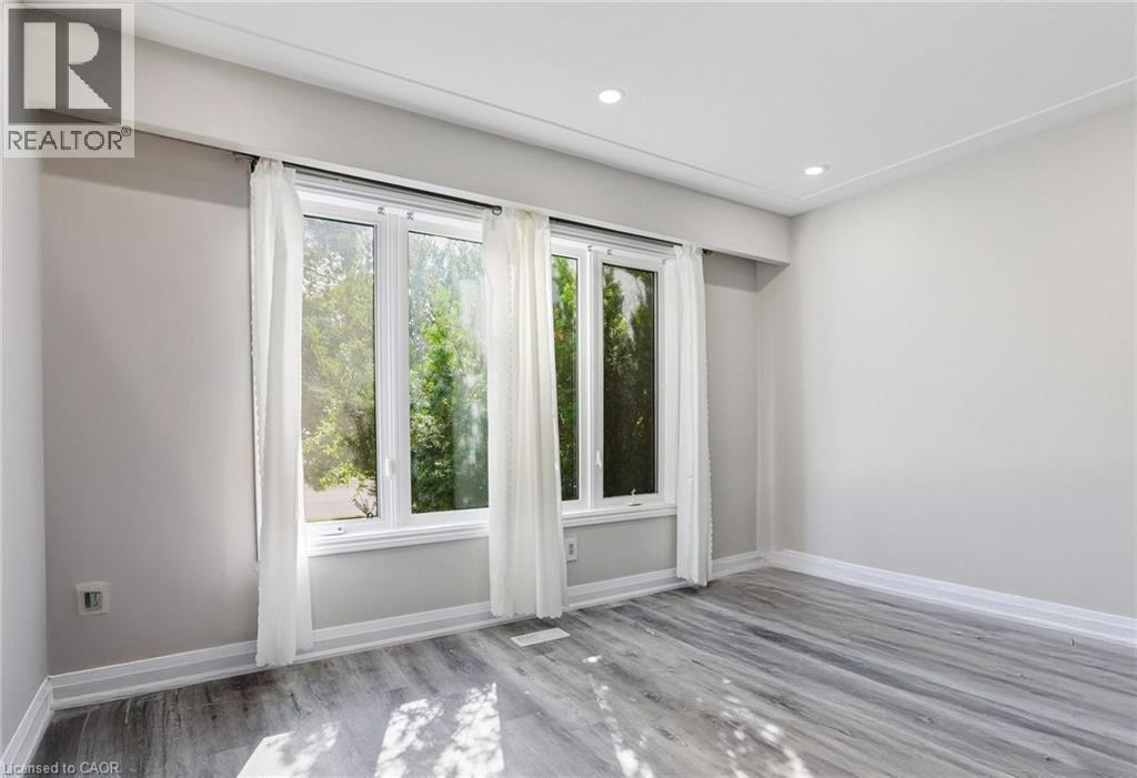 Unfurnished room with light wood-style floors and recessed lighting - 7 Cardill Crescent, Waterloo, ON - Indoor Photo Showing Other Room