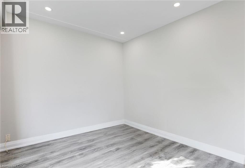 Spare room with recessed lighting and light wood-style floors - 7 Cardill Crescent, Waterloo, ON - Indoor Photo Showing Other Room