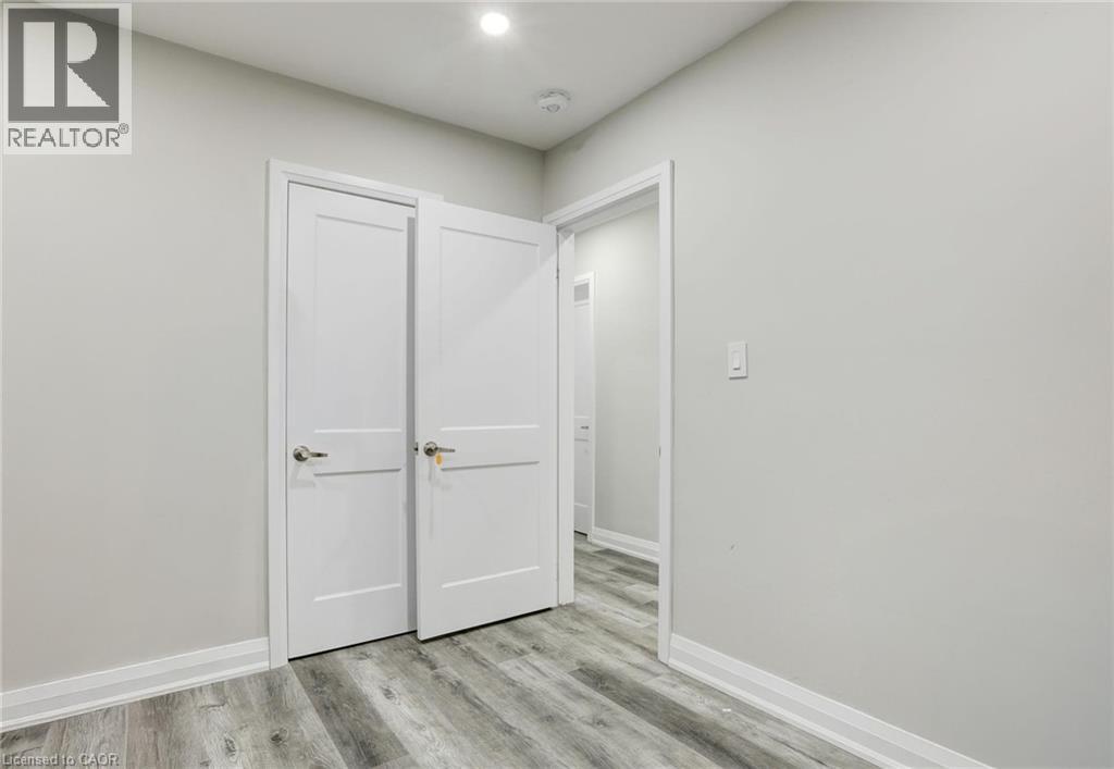 Unfurnished bedroom with baseboards and light wood-type flooring - 7 Cardill Crescent, Waterloo, ON - Indoor Photo Showing Other Room