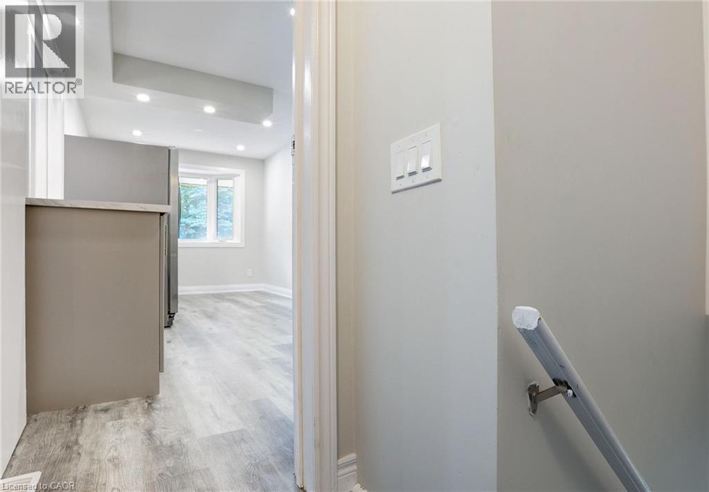 Hall with light wood-style flooring and recessed lighting - 7 Cardill Crescent, Waterloo, ON - Indoor Photo Showing Other Room