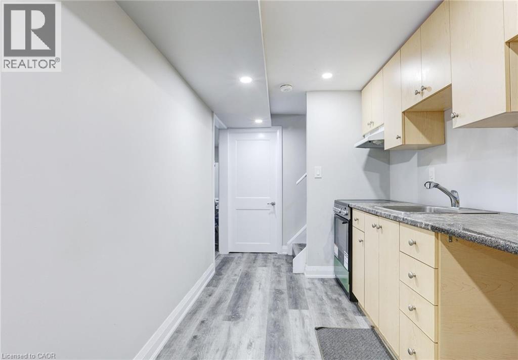 Kitchen with recessed lighting, light wood-style flooring, electric range, and light wood finish cabinets - 7 Cardill Crescent, Waterloo, ON - Indoor Photo Showing Kitchen