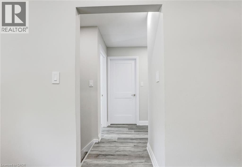 Corridor with light wood-style floors and baseboards - 7 Cardill Crescent, Waterloo, ON - Indoor Photo Showing Other Room