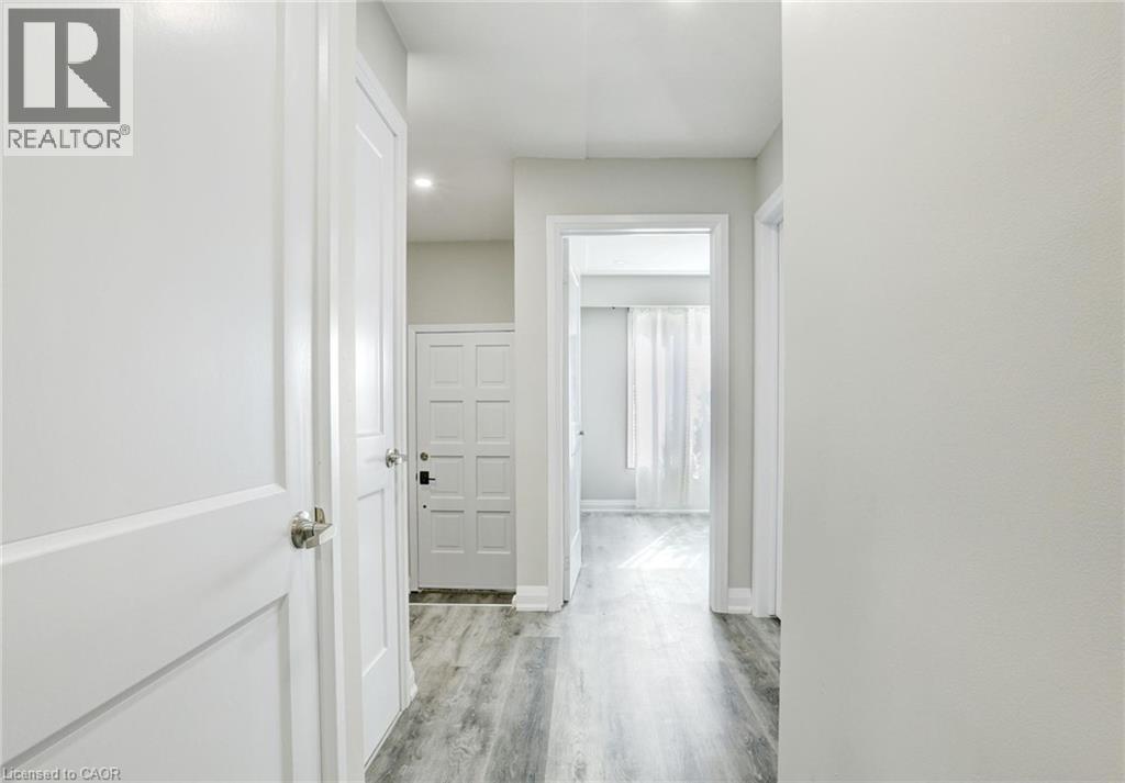 Hall featuring light wood-style flooring and baseboards - 7 Cardill Crescent, Waterloo, ON - Indoor Photo Showing Other Room