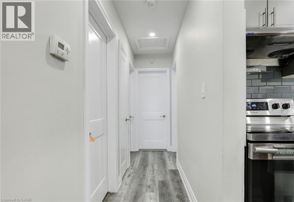 Corridor with light wood-style floors and recessed lighting - 7 Cardill Crescent, Waterloo, ON - Indoor