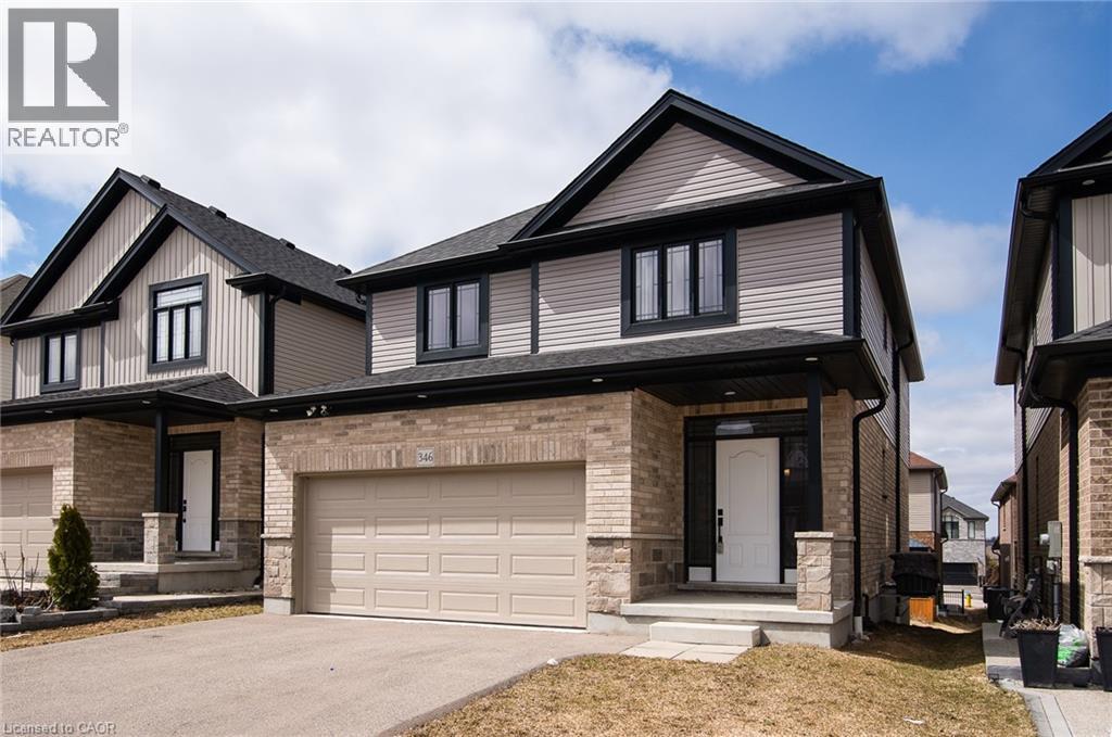 View of front of home featuring asphalt driveway, brick siding, an attached garage, a shingled roof, and stone siding - 346 Chokecherry Crescent, Waterloo, ON - Outdoor