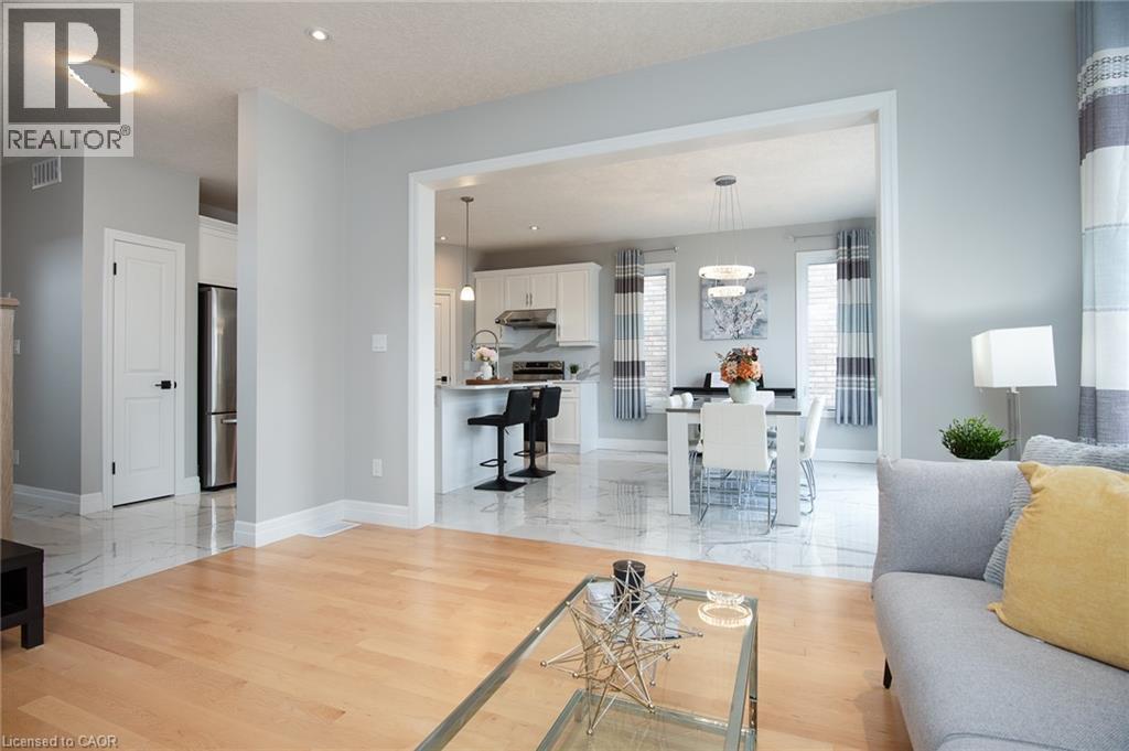 Living room with light wood-style floors and recessed lighting - 346 Chokecherry Crescent, Waterloo, ON - Indoor Photo Showing Living Room