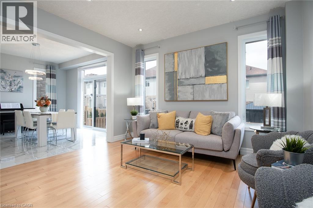 Living area with plenty of natural light and light wood-style flooring - 346 Chokecherry Crescent, Waterloo, ON - Indoor Photo Showing Living Room