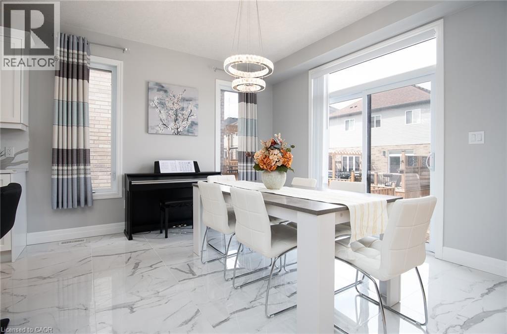 Dining room featuring hanging lights and light marble finish floors - 346 Chokecherry Crescent, Waterloo, ON - Indoor Photo Showing Dining Room