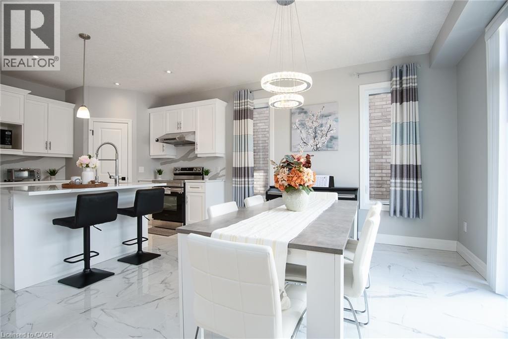 Dining space featuring light marble finish floors and a chandelier - 346 Chokecherry Crescent, Waterloo, ON - Indoor Photo Showing Kitchen With Upgraded Kitchen