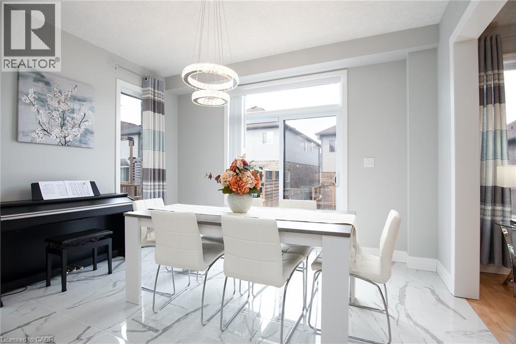 Dining space featuring light marble finish floors and baseboards - 346 Chokecherry Crescent, Waterloo, ON - Indoor Photo Showing Dining Room