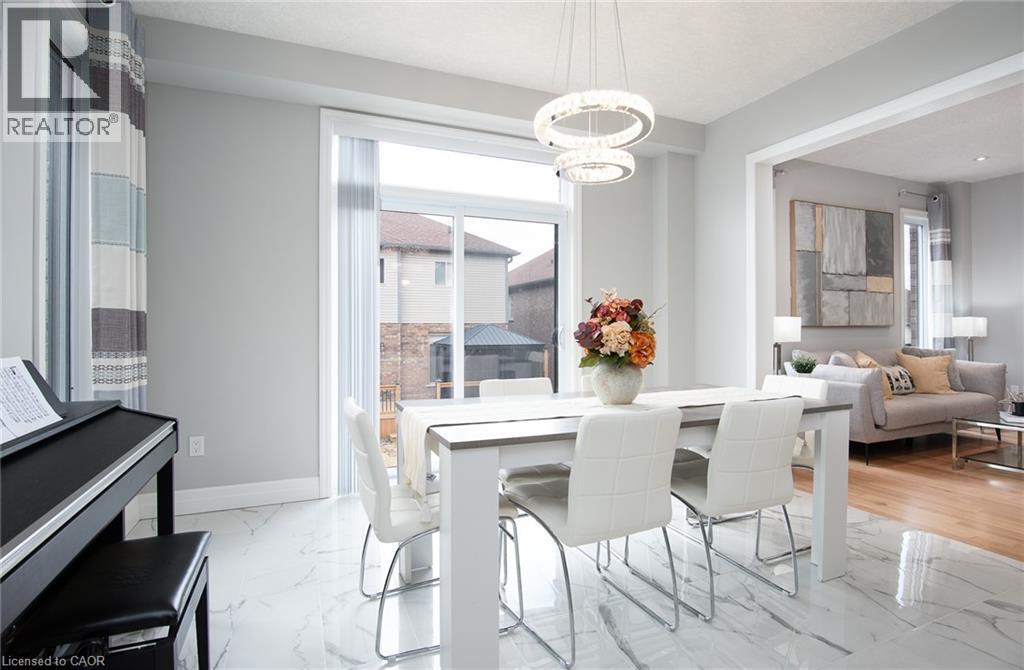 Dining room with hanging lights and light marble finish flooring - 346 Chokecherry Crescent, Waterloo, ON - Indoor Photo Showing Dining Room