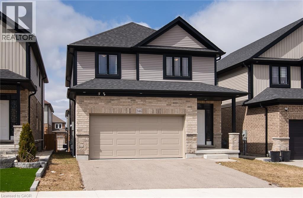 View of front of home featuring driveway, an attached garage, a shingled roof, and brick siding - 346 Chokecherry Crescent, Waterloo, ON - Outdoor With Facade