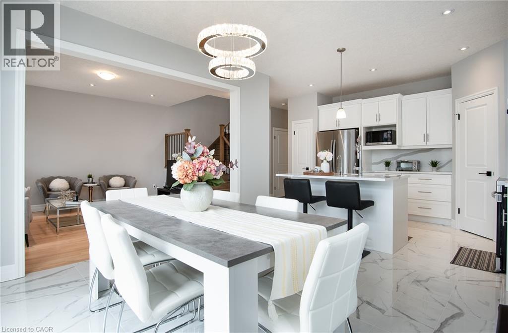Dining area featuring a chandelier and light marble finish flooring - 346 Chokecherry Crescent, Waterloo, ON - Indoor Photo Showing Dining Room