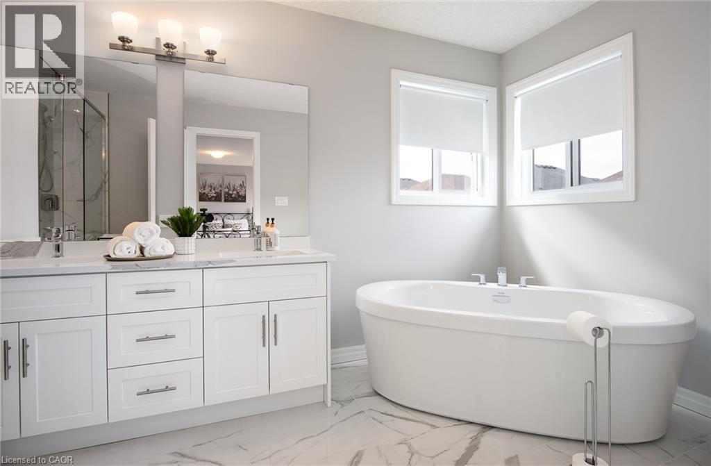 Full bathroom featuring a marble finish shower, double vanity, light marble finish floors, and a freestanding bath - 346 Chokecherry Crescent, Waterloo, ON - Indoor Photo Showing Bathroom