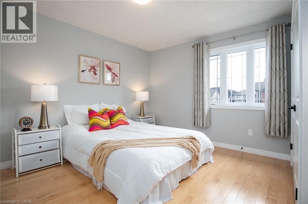 Bedroom with light wood-type flooring and a textured ceiling - 346 Chokecherry Crescent, Waterloo, ON - Indoor Photo Showing Bedroom