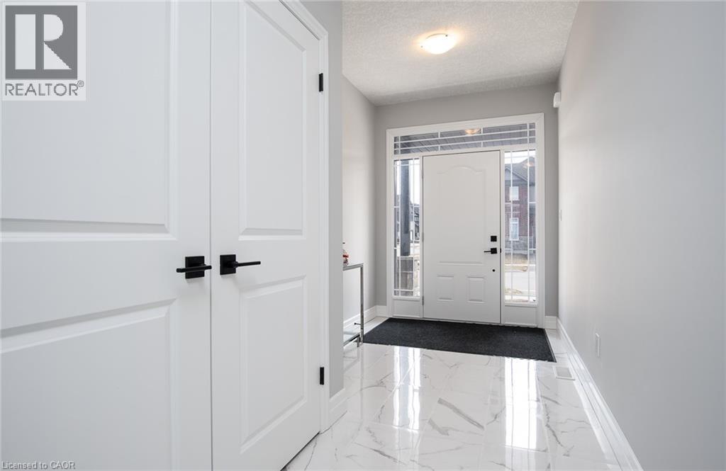 Foyer entrance with a textured ceiling and dark marble finish flooring - 346 Chokecherry Crescent, Waterloo, ON - Indoor Photo Showing Other Room