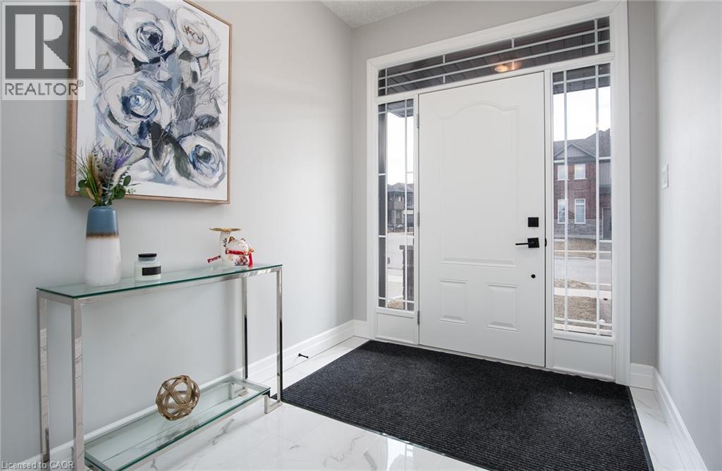 Foyer featuring light marble finish floors and healthy amount of natural light - 346 Chokecherry Crescent, Waterloo, ON - Indoor Photo Showing Other Room