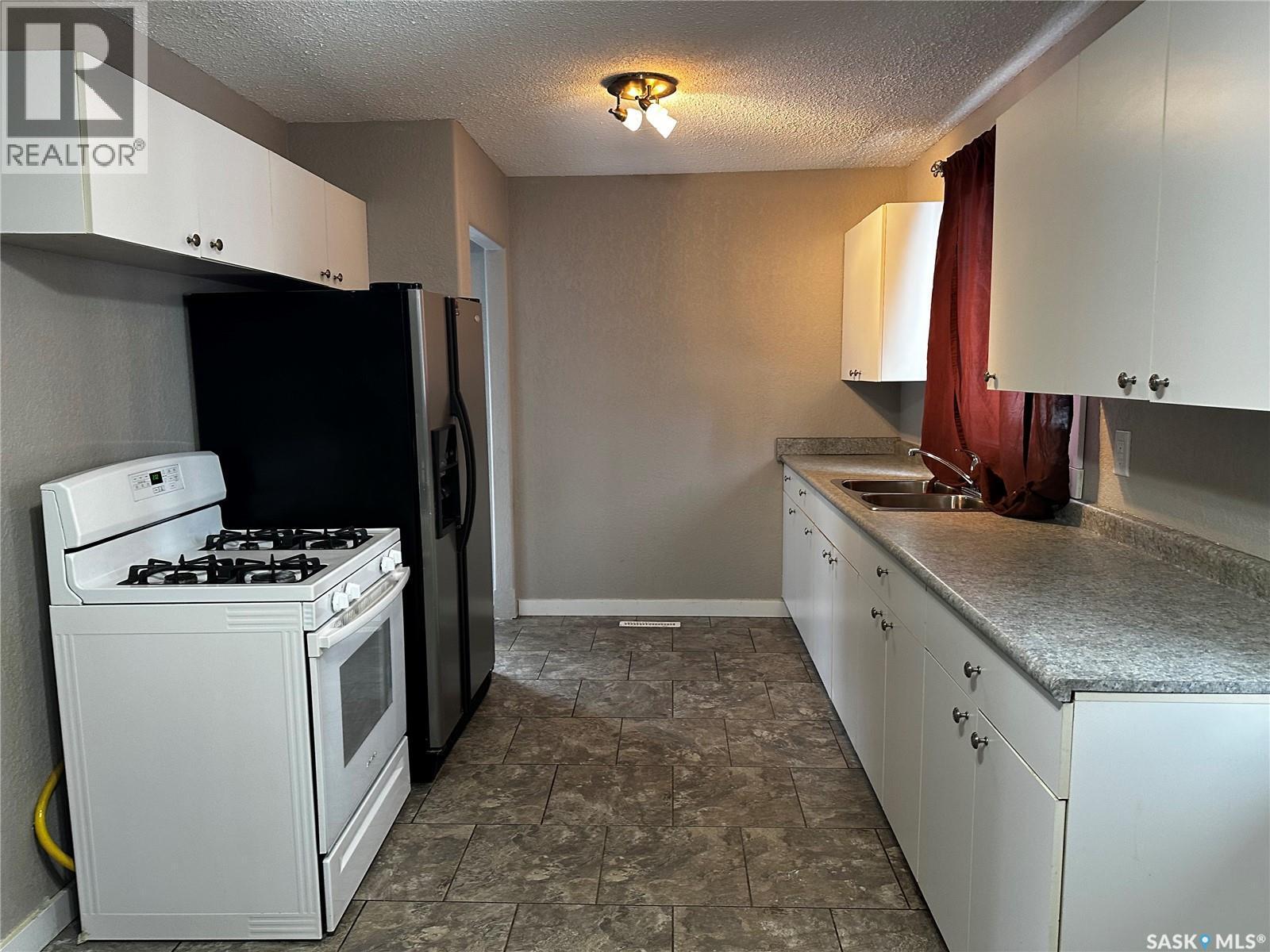 619 Guy Place, La Ronge, SK - Indoor Photo Showing Kitchen With Double Sink