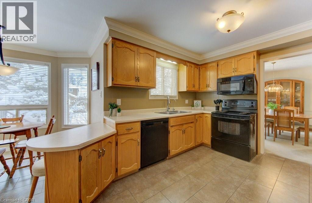Oak cabinetry - 594 Hunters Place, Waterloo, ON - Indoor Photo Showing Kitchen With Double Sink