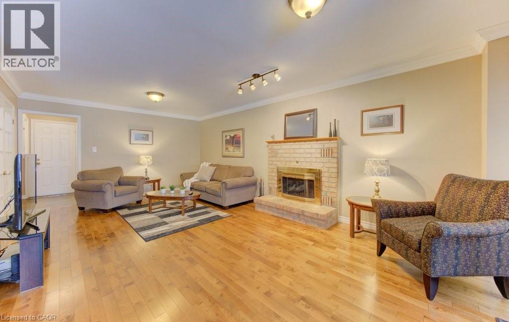 Hardwood flooring - 594 Hunters Place, Waterloo, ON - Indoor Photo Showing Living Room With Fireplace