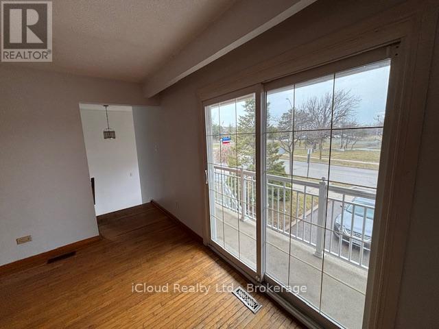Strip Hardwood Floors & W/O To Balcony - 4174 Woodington Drive, Mississauga, ON - Indoor Photo Showing Other Room