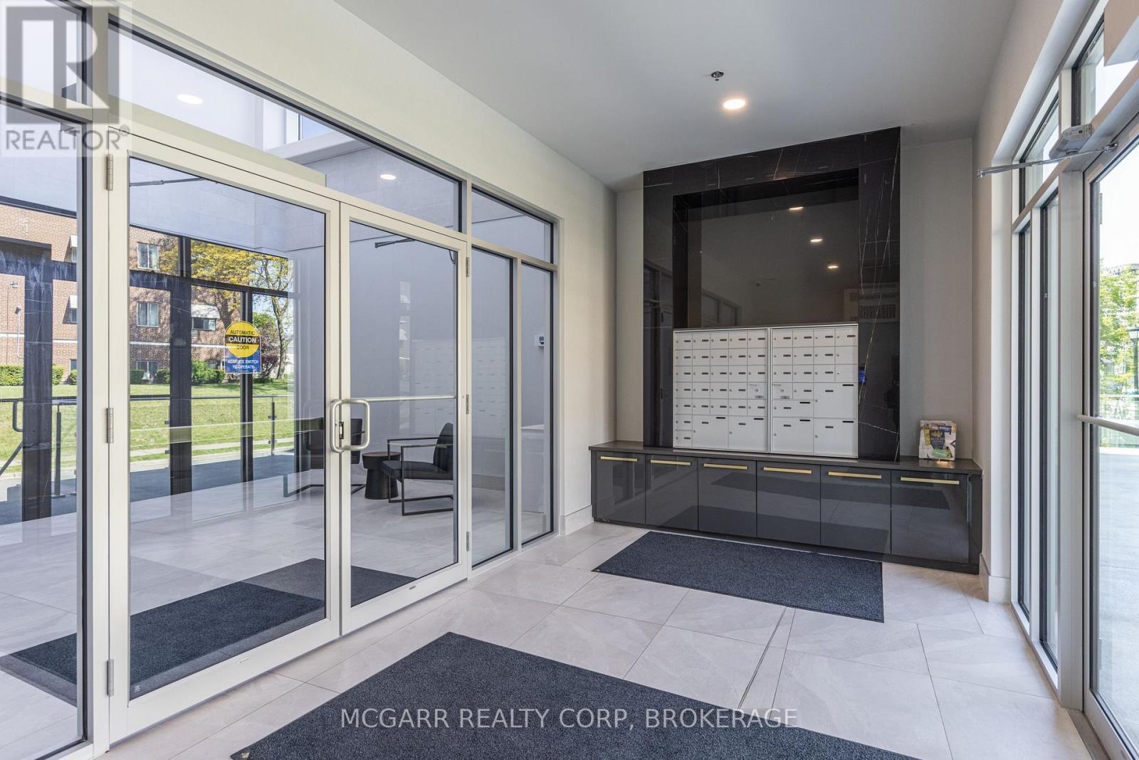 Front lobby with mail pickup - 507 - 77 Yates Street, St. Catharines (Downtown), ON - Indoor Photo Showing Other Room