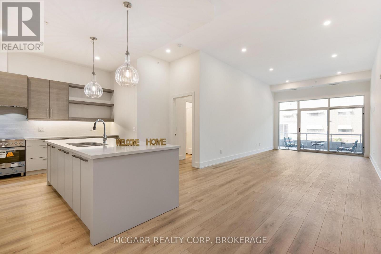 Large centre island - 507 - 77 Yates Street, St. Catharines (Downtown), ON - Indoor Photo Showing Kitchen With Upgraded Kitchen