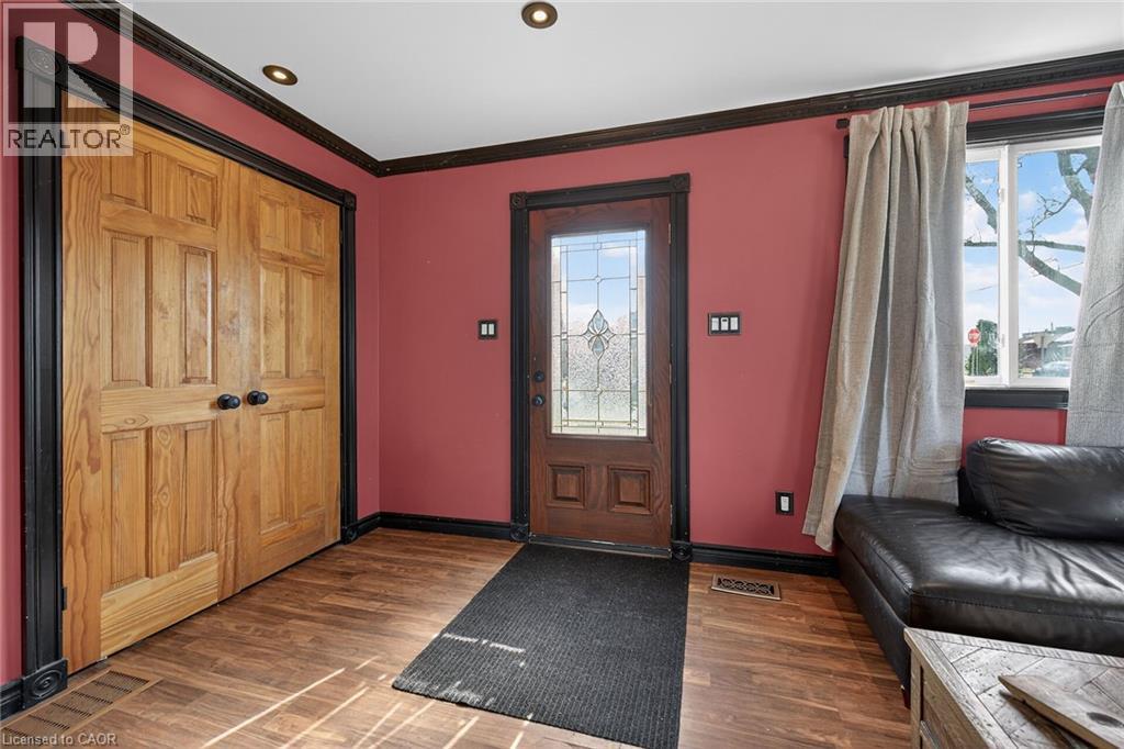 Foyer featuring dark wood finished floors and ornamental molding - 703 Dunn Avenue, Hamilton, ON - Indoor Photo Showing Other Room