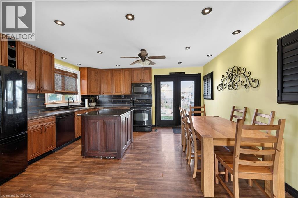 Kitchen with black appliances, french doors, dark wood-style floors, recessed lighting, and backsplash - 703 Dunn Avenue, Hamilton, ON - Indoor Photo Showing Other Room