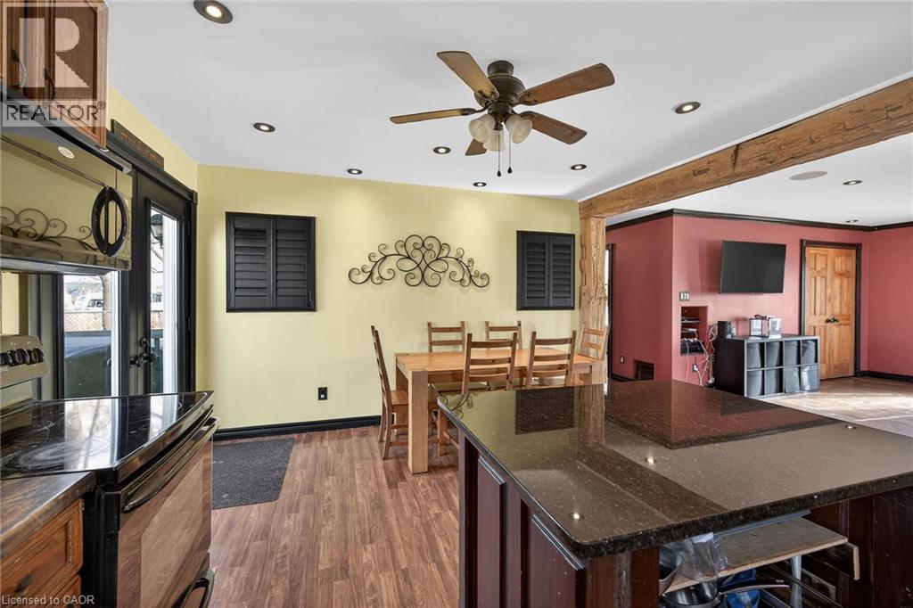 Kitchen featuring black appliances, dark stone counters, dark wood-style floors, recessed lighting, and ceiling fan - 703 Dunn Avenue, Hamilton, ON - Indoor
