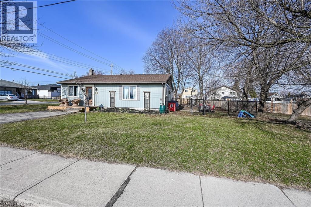 View of front of house featuring a chimney and a playground - 703 Dunn Avenue, Hamilton, ON - Outdoor